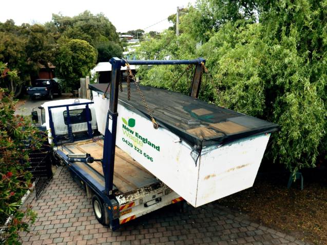 Truck (lorry) loading a full skip waste management container